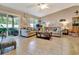 Comfortable living room with sliding glass doors, neutral tones, and ample seating arrangements at 1511 W Magnolia St, Clermont, FL 34711