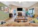 Open-concept living room featuring a fireplace, sliding glass doors, and a view of the kitchen at 1511 W Magnolia St, Clermont, FL 34711