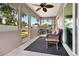 Relaxing screened patio with wicker furniture and a ceiling fan, perfect for outdoor enjoyment at 1511 W Magnolia St, Clermont, FL 34711