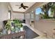Cozy screened patio with plants and a ceiling fan offers a tranquil outdoor living space at 1511 W Magnolia St, Clermont, FL 34711