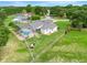 Aerial view showcasing the pool, fenced yard, and landscaped grounds of this beautiful home at 15629 Catherine Cir, Groveland, FL 34736