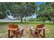Inviting backyard with a stone fire pit and two Adirondack chairs, perfect for outdoor gatherings at 15629 Catherine Cir, Groveland, FL 34736