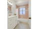 Full bathroom featuring marble floors, decorative pink tiles, and updated vanity with sink at 15629 Catherine Cir, Groveland, FL 34736