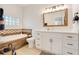Bright bathroom featuring a soaking tub, stylish tile accents, and a vanity with white countertop at 15629 Catherine Cir, Groveland, FL 34736