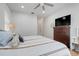 Spacious bedroom with ceiling fan, wooden dresser, and light wood floors at 15629 Catherine Cir, Groveland, FL 34736