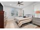 Bright bedroom with a ceiling fan, neutral color palette, and two windows at 15629 Catherine Cir, Groveland, FL 34736