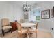 Bright dining area featuring modern light fixture, a table with 4 chairs and hardwood floors at 15629 Catherine Cir, Groveland, FL 34736
