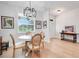 Bright dining area featuring modern light fixture, a table with 4 chairs and hardwood floors at 15629 Catherine Cir, Groveland, FL 34736