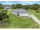 Charming home with a well-manicured lawn, blue shutters, and a welcoming driveway at 15629 Catherine Cir, Groveland, FL 34736