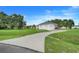A well-maintained home on a large lot, featuring a long driveway leading to an attached garage at 15629 Catherine Cir, Groveland, FL 34736