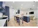Kitchen with blue cabinets, stainless appliances, island, and wood floors at 15629 Catherine Cir, Groveland, FL 34736