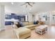 Open-concept living room featuring blue kitchen, dining area, and bright natural light at 15629 Catherine Cir, Groveland, FL 34736