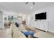 Open concept living room with hardwood floors, front door view, and dining area at 15629 Catherine Cir, Groveland, FL 34736
