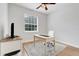 Bright office space featuring hardwood floors, a ceiling fan and a large window providing natural light at 15629 Catherine Cir, Groveland, FL 34736