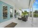 Relaxing screened-in patio featuring cozy seating, overhead fan, and views of the pool at 15629 Catherine Cir, Groveland, FL 34736