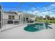 A screened in pool that is surrounded by a fenced patio with seating, and backyard views at 15629 Catherine Cir, Groveland, FL 34736