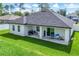 Home featuring a covered patio, a lush lawn, and a white perimeter fence at 1620 6Th Ave, Deland, FL 32724