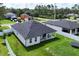 Aerial of a home's backyard featuring a covered patio and a white fence at 1620 6Th Ave, Deland, FL 32724