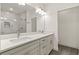 Bathroom features dual sinks, white countertops, and a glass door shower with elegant tile at 1620 6Th Ave, Deland, FL 32724