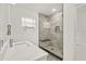 Bathroom features a glass shower with marble-look tile, a bench, and tiled niche at 1620 6Th Ave, Deland, FL 32724