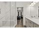 Bathroom features white countertops, dual sinks, a glass door shower with marble and access to the main bedroom at 1620 6Th Ave, Deland, FL 32724