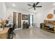 Bedroom features natural lighting, colorful curtains, a ceiling fan, and a computer desk and chair at 1620 6Th Ave, Deland, FL 32724