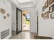 Bright entryway with gray tiled flooring, decorative wall art, and a glass-paneled front door at 1620 6Th Ave, Deland, FL 32724