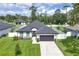 Charming single-story home with a well-manicured lawn, gray roof, white exterior, and a two-car garage at 1620 6Th Ave, Deland, FL 32724