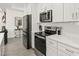 Contemporary kitchen with stainless steel appliances, white countertops, and modern fixtures at 1620 6Th Ave, Deland, FL 32724