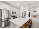Bright kitchen with white cabinets, stainless steel appliances, and a spacious island with pendant lighting at 1620 6Th Ave, Deland, FL 32724
