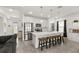 Modern kitchen with white cabinets, stainless steel appliances, a large island with seating, and tile flooring at 1620 6Th Ave, Deland, FL 32724