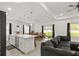 Open-concept living space with a kitchen island, dining area, and a comfortable gray sofa at 1620 6Th Ave, Deland, FL 32724