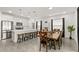 Open living space combining kitchen and dining areas, featuring modern appliances and a stylish dining table at 1620 6Th Ave, Deland, FL 32724
