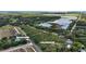 Expansive aerial view of property location including Lake Apopka and surrounding land, showcasing the gated entry at 16318, 16250 & 16300 County Road 448, Mount Dora, FL 32757
