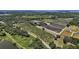 Expansive aerial view of a lush landscape with rows of plant nurseries and green pastures at 16318, 16250 & 16300 County Road 448, Mount Dora, FL 32757