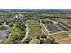 Wide aerial view of an expansive property with multiple fields and green spaces under a clear, sunny sky at 16318, 16250 & 16300 County Road 448, Mount Dora, FL 32757