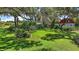 Expansive backyard adorned with large trees and verdant foliage offering a serene retreat at 16318, 16250 & 16300 County Road 448, Mount Dora, FL 32757