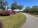 Picturesque driveway lined with blooming azaleas and lush greenery, leading up to a serene and inviting property at 16318, 16250 & 16300 County Road 448, Mount Dora, FL 32757