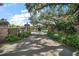 Impressive gated entrance with brick pillars, a star-emblazoned gate, and a winding driveway at 16318, 16250 & 16300 County Road 448, Mount Dora, FL 32757