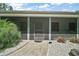 A home entrance with a screen door and landscaping at 16318, 16250 & 16300 County Road 448, Mount Dora, FL 32757