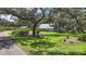 Beautifully landscaped property with mature trees and a well-maintained lawn, showcasing the home's curb appeal at 16318, 16250 & 16300 County Road 448, Mount Dora, FL 32757