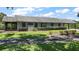 Exterior view of the house showcasing the lawn, hedges, and attached porch at 16318, 16250 & 16300 County Road 448, Mount Dora, FL 32757