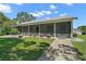 Attractive screened-in porch, complemented by a well-manicured lawn and inviting walkway at 16318, 16250 & 16300 County Road 448, Mount Dora, FL 32757