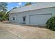 Exterior view of a large detached garage with concrete driveway and ample parking space at 16318, 16250 & 16300 County Road 448, Mount Dora, FL 32757