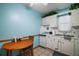Bright kitchen with white cabinets, breakfast table, and ample counter space at 16318, 16250 & 16300 County Road 448, Mount Dora, FL 32757