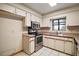 This kitchen features tiled floors, stainless steel appliances and white cabinets at 16318, 16250 & 16300 County Road 448, Mount Dora, FL 32757