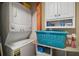 Convenient laundry room with a stacked washer and dryer, storage, and shelving at 16318, 16250 & 16300 County Road 448, Mount Dora, FL 32757