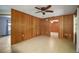 Expansive living area enhanced by wood paneling and a ceiling fan at 16318, 16250 & 16300 County Road 448, Mount Dora, FL 32757