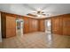 Large living area features wood paneling and an open floor plan with several doorways at 16318, 16250 & 16300 County Road 448, Mount Dora, FL 32757