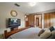 A view from the bed featuring hardwood floors, a television, and access to another room at 16318, 16250 & 16300 County Road 448, Mount Dora, FL 32757
